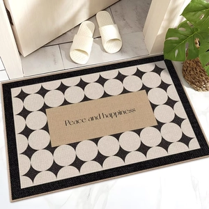 Detail view of French style indoor floor mat with geometric pattern and Peace and happiness text