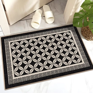 Detail of French luxury door mat with geometric black and white patterns and non-slip texture