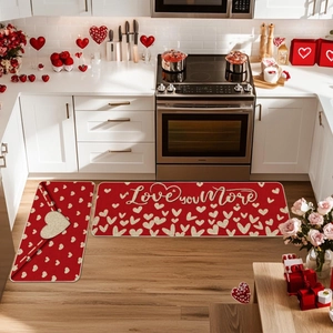 Detail view of 2-piece red kitchen mat set with golden heart patterns and Love You More text
