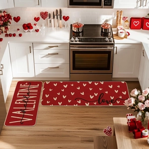 Detail view of red Valentine-themed kitchen mats with gold hearts in a home setting