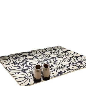 Bohemian rectangle rug with white daisy patterns on dark navy background with white boots