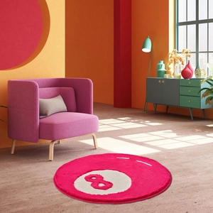 Detail of round faux cashmere 8-ball rug in pink and white with soft velvet texture
