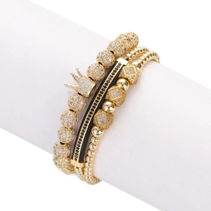 Close-up of three-piece crown charm bracelet set with black and gold zircon beads