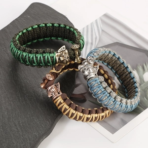 Detailed view of woven paracord bracelets with antique metal animal head charms