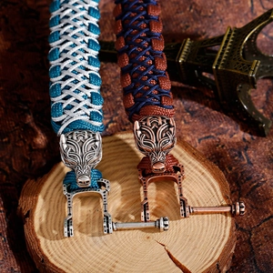 Adjustable paracord bracelet for men with intricately carved metal wolf head and U-buckle