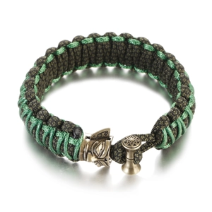 Detailed close-up of handmade green paracord bracelet with antique owl metal clasp