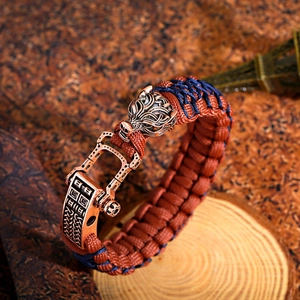 Detail of woven viking bracelet featuring bronze wolf head and mechanical clasp