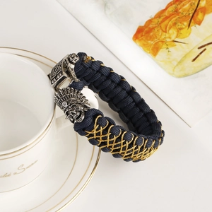 Detailed close-up of handmade braided rope bracelet with engraved skull metal clasp
