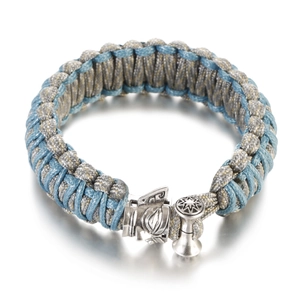 Close-up of woven paracord bracelet with silver star compass buckle detail