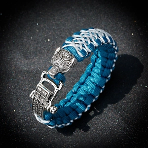 Detailed view of Viking style paracord bracelet featuring a carved wolf head metal clasp