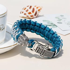 Detailed wolf head ornament on blue paracord bracelet with Nordic rune metal buckle