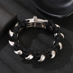 Detailansicht eines schwarzen Paracord-Armbands mit silbernen Krallen und Metallschnalle