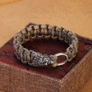 Braided paracord survival bracelet with detailed tribal skull head metal clasp