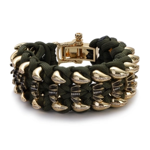Detail of green paracord bracelet with golden metal claws and sparkling zircon stones