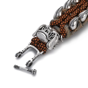 Macro view of woven paracord bracelet with silver bulldog charm and claw details