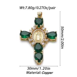 Macro view of gold cross pendant with green pear-shaped gems and Virgin Mary relief