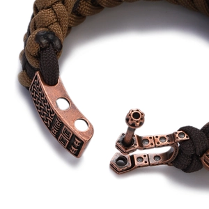 Macro shot of bicolor paracord bracelet with antique bronze buckle and Celtic engravings