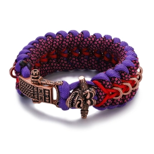 Detail of woven paracord bracelet with antique bronze dragon head and metal clasp buckle