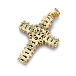 Detailed close-up of a gold cross pendant with emerald green gemstones and a tiered design