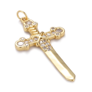 Detailed view of a gold cross sword pendant with shimmering micro-paved cubic zirconia