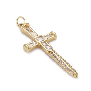 Detail of gold cross pendant with micro-pave cubic zirconia on white background