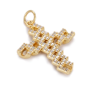 Macro shot of gold-plated cross pendant with micro-pave white zircon layered structure