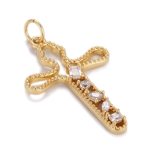 Detailed close-up of a gold cross pendant with intricate micro-pave cubic zirconia stones