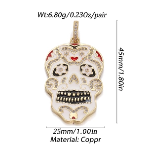 Macro detail of gold-plated skull pendant with white enamel and cubic zirconia stones