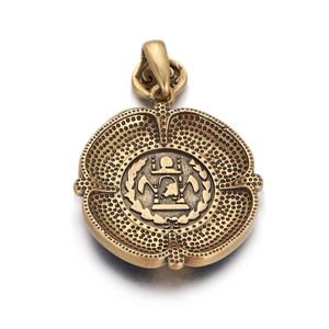 Macro detail of a vintage bronze Roman coin pendant with gold plating and floral border