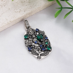 Macro detail of vintage gothic lion head pendant with green gems and antique silver finish