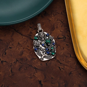 Macro detail of retro 18K gold skull pendant with inlaid colorful zircon and relief eagle