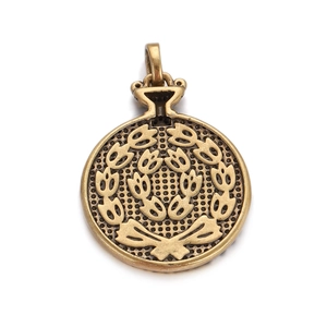 Detailed macro view of vintage bronze Roman pendant with laurel wreath and bow accents