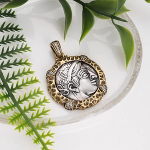 Detailed macro of vintage Roman coin pendant with gold hammered texture and cubic zirconia