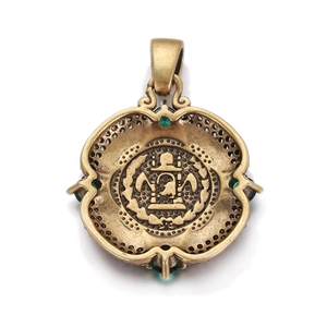 Detailed close-up of retro bronze portrait coin pendant with green gemstones inlay