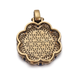 Detailed back view of vintage bronze flower pendant with hollow petals and blue stone