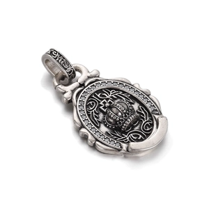 Detailed close-up of a vintage hip-hop crown pendant with zircon stones and aging effect