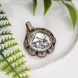 Detailed close-up of a vintage Roman coin pendant with silver relief and colorful gemstones