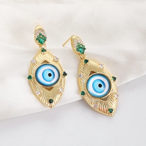 Detail of gold evil eye earrings featuring blue center stones and micro-pave zircons