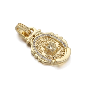 Close-up of gold crown medallion pendant with embossed vintage patterns and clear zircon stones