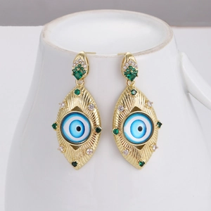 Detailed view of evil eye drop earrings with gold plating and emerald zircon accents