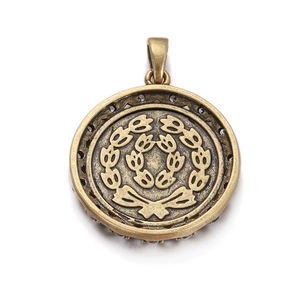 Macro view of vintage bronze Roman coin pendant with wreath relief and lace edge