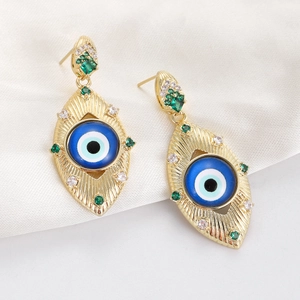 Macro detail of Evil Eye drop earrings with gold texture and colorful rhinestones