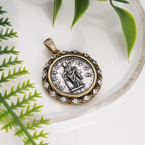 Detailed close-up of retro Roman coin pendant with gold and silver plating and zircon inlay