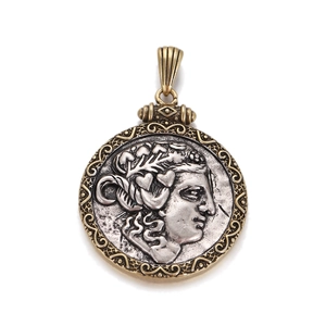 Vintage gold and silver bronze coin pendant featuring a Roman god relief portrait