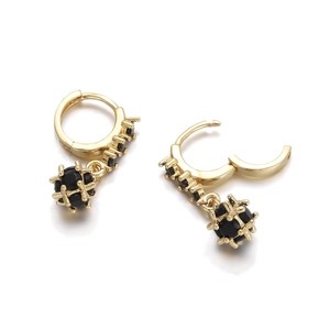 Macro detail of 18K gold-plated earring hoops with faceted black zircon sphere drops
