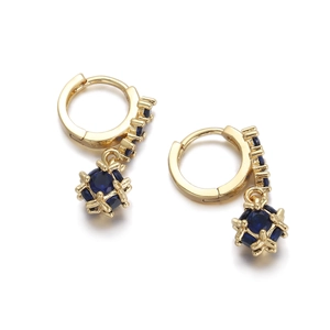 Macro detail of 18K gold-plated drop earrings with deep blue zircons and secure hoop clasps