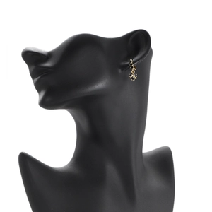 Elegant 18K gold plated zircon drop earrings with black stones on a black model profile