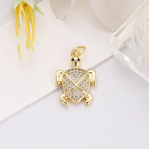 Detail of 18K gold plated turtle pendant featuring sparkling white zircon shell and black eyes