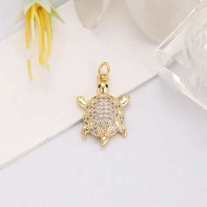 Detailed view of an 18K gold plated sea turtle pendant with micro-inlaid zircons