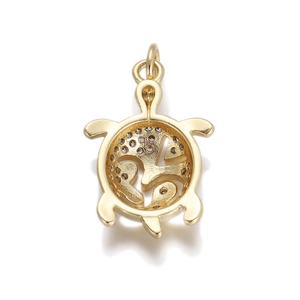 Detailed view of a gold turtle pendant featuring a hollow shell and clear zircon accents